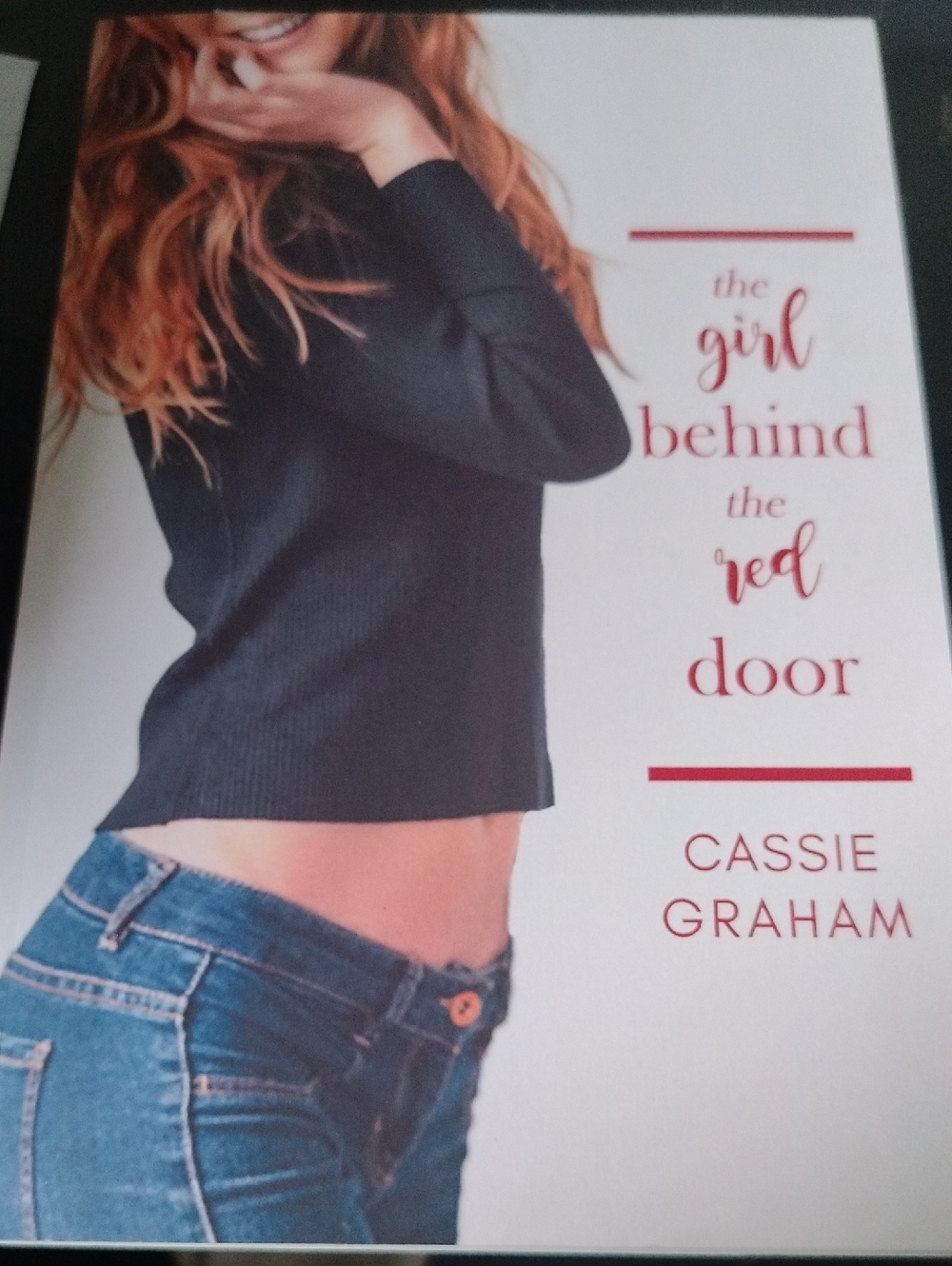 The Girl Behind the Red Door by Cassie Graham - Black Sweater Cover
